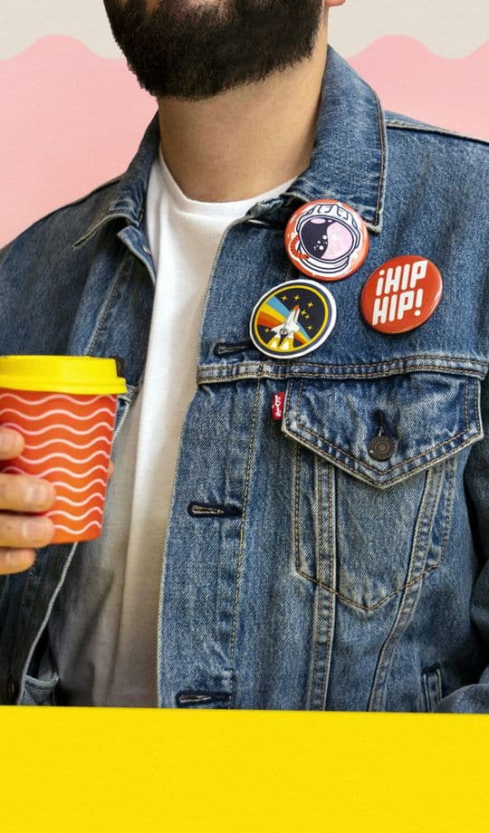 Man holding a branded coffee cup